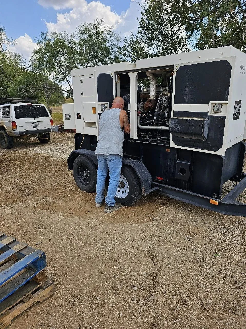 Technician working on a large mobile generator.